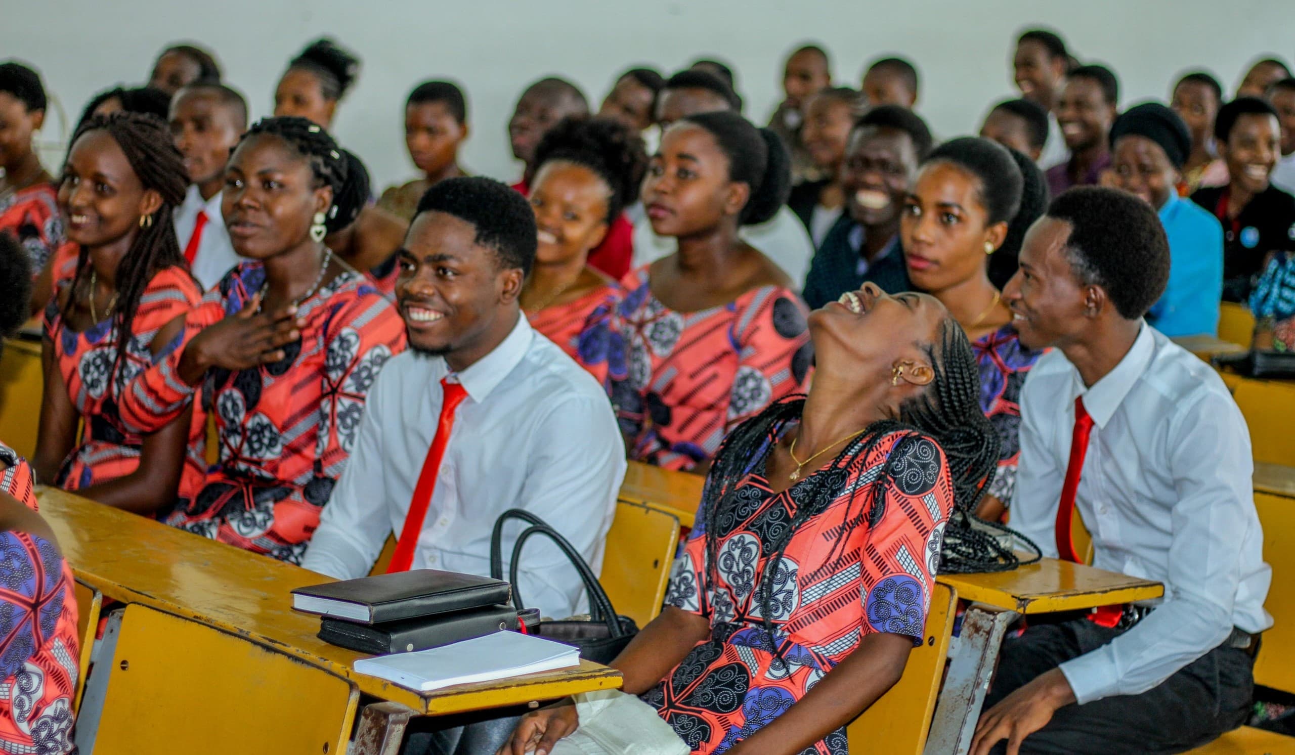 University learners smiling together in a lecture hall