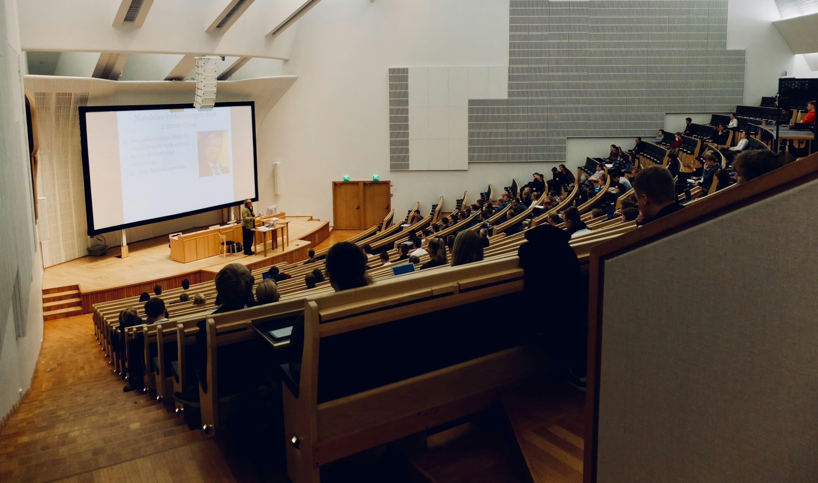 Learners seated in a large lecture hall during a presentation