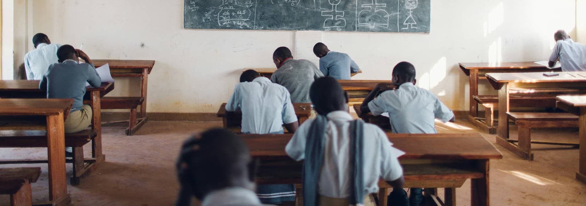 A classroom of learners seated at their desks during an exam