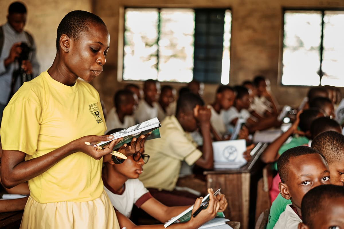 A learner reading through her workbook during a lesson